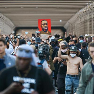 Marchers cross the Brooklyn Bridge demanding police reform after a commemoration to honor the anniversary of George Floyd's death on May 25, 2021 in New York City.