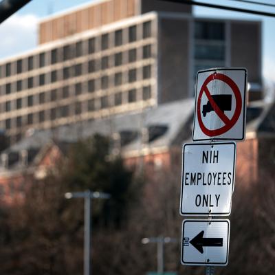 A sign that reads "NIH Employees Only" near an entrance at the National Institute of Health in Bethesda, Maryland.
