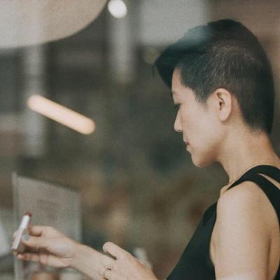 A woman trying out a lipstick in a store.