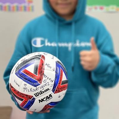A fifth grader who left Areli Rodriguez's Texas classroom because his family feared being detained by immigration agents holds the signed soccer ball he received as a parting gift.