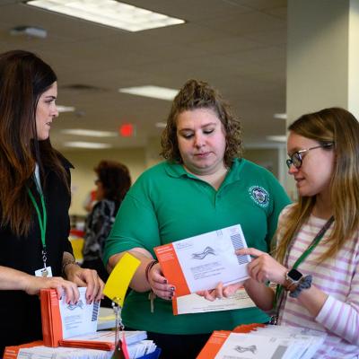 Election workers review a mail-in ballot with an incorrect signature at Chester County's central scanning location in West Chester, Pennsylvania.