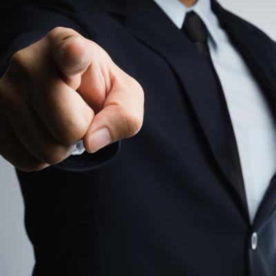 A businessman aggressively pointing a finger.