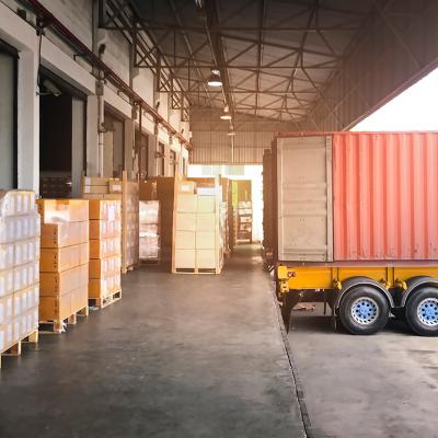 Cargo shipment and a trailer truck parked for loading at a dock warehouse.