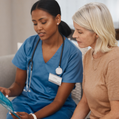 A medical professional reading an informational pamphlet to a patient