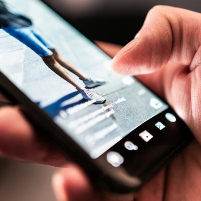 A focus on a user consuming reels and viral social media clips.