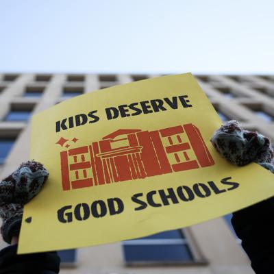 "Kids Deserve Good Schools" sign being held during a rally in front of the Department of Education on March 13, 2025 in Washington, D.C.
