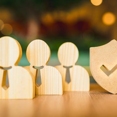 Wooden symbols for employees and a shield for insurance.