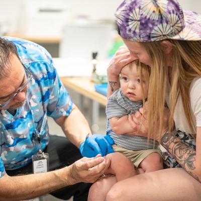 One year-old River Jacobs is held by his mother while he receives an MMR vaccine at a vaccine clinic in Lubbock, Texas. 