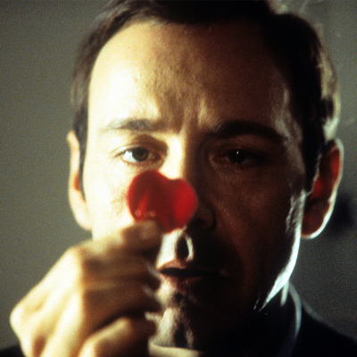 Kevin Spacey staring at a rose pedal in a scene from the film 'American Beauty’.