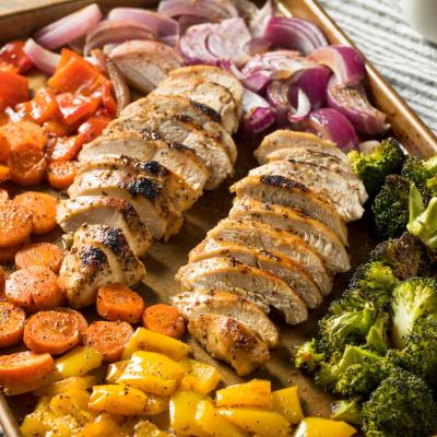 Close-up of homemade keto sheet pan chicken with rainbow vegetables.