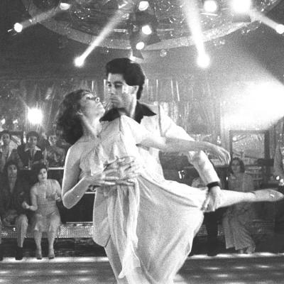 John Travolta dances with Karen Lynn Gorney in a scene from Saturday Night Fever, directed by John Badham.