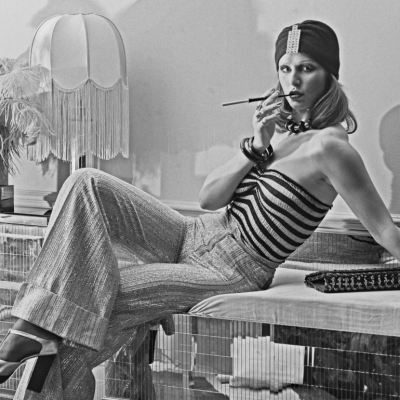 A model wearing wide-legged trousers, a striped tube top and a turban-style hat at the Biba boutique in London, UK, 6th September 1973.