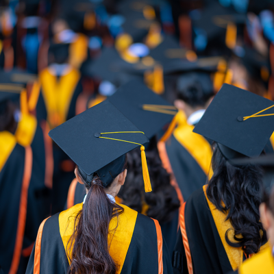Graduates in caps and gown at commencement.