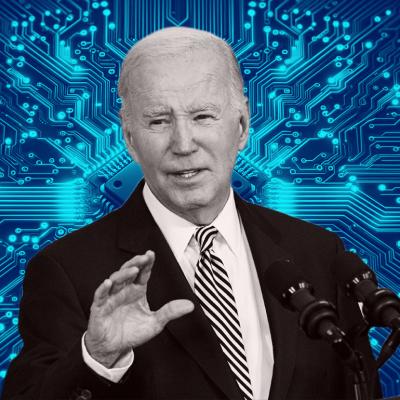 US President Joe Biden delivers remarks in the White House with blue processor graphic in background.