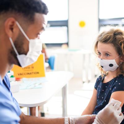 A toddler getting a vaccination from her pediatrician