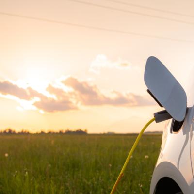 A charging vehicle with a sunset in the background.