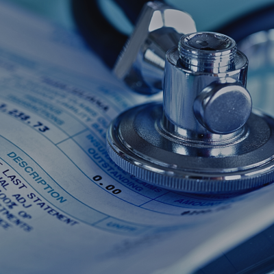 A stethoscope sitting on top of a medical bill. 