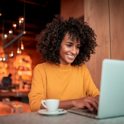 A woman using a laptop in a cafe.