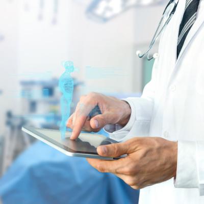 Doctor with stethoscope using tablet for remote monitoring.