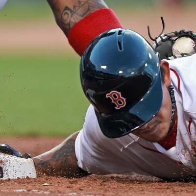 A Red Sox player is tagged out at first base