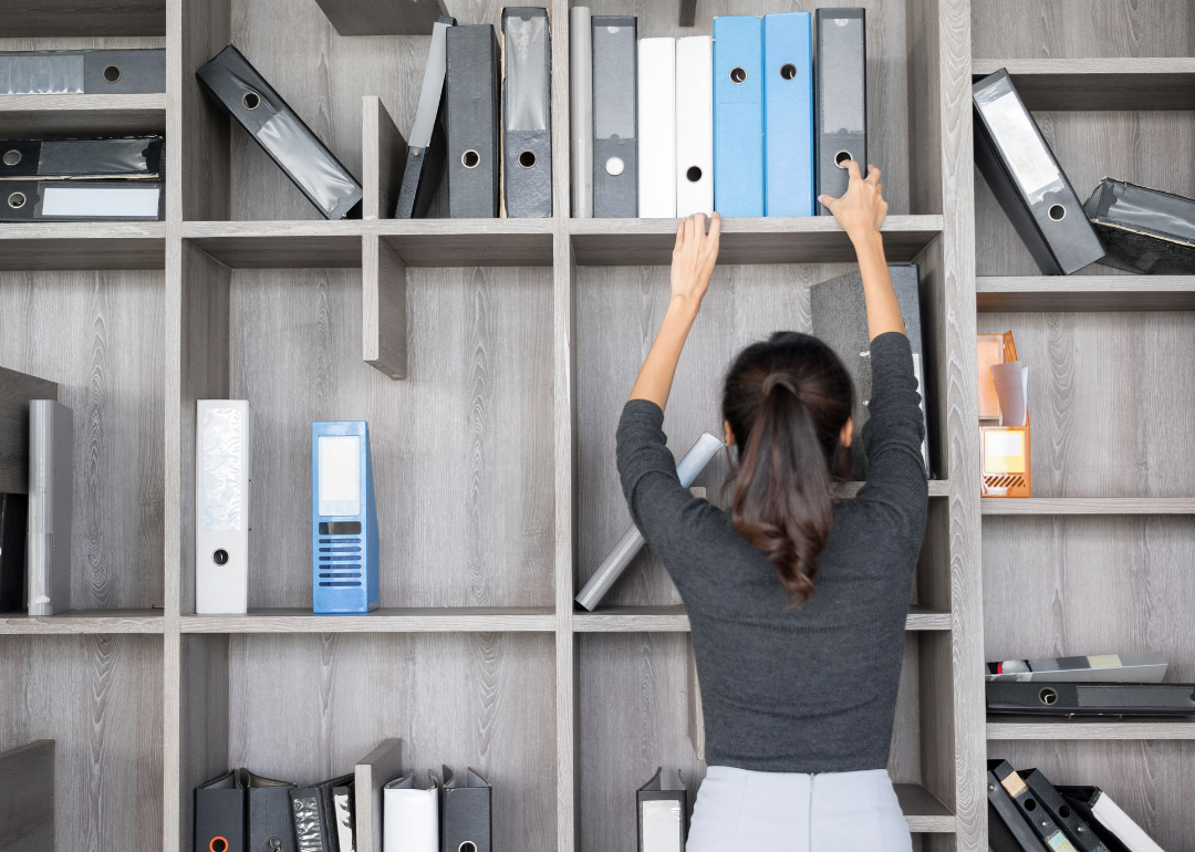A person organizing their office.