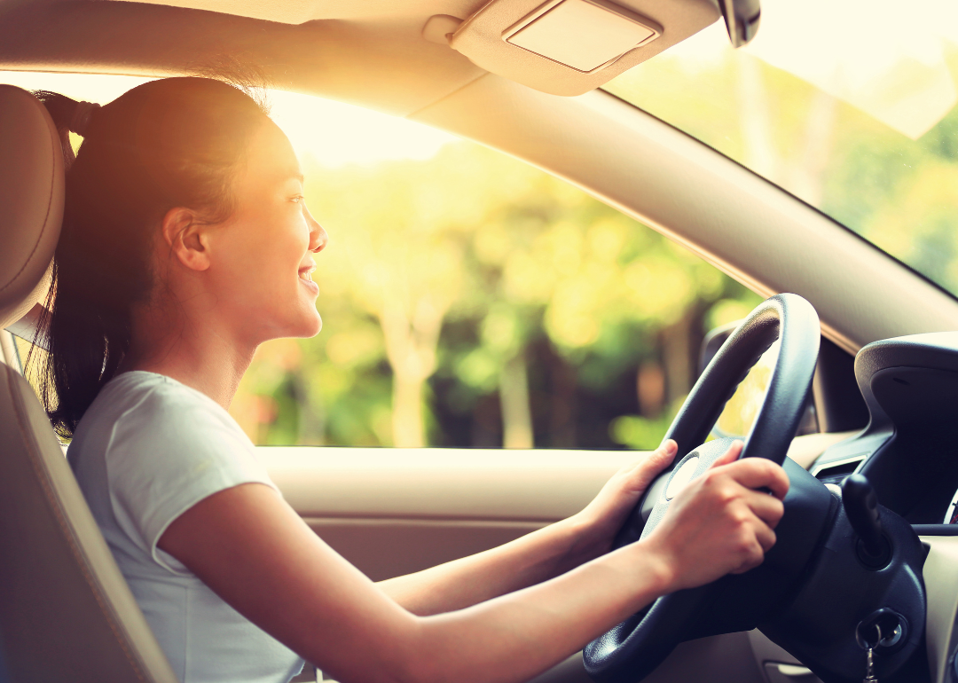 A young person driving a car.