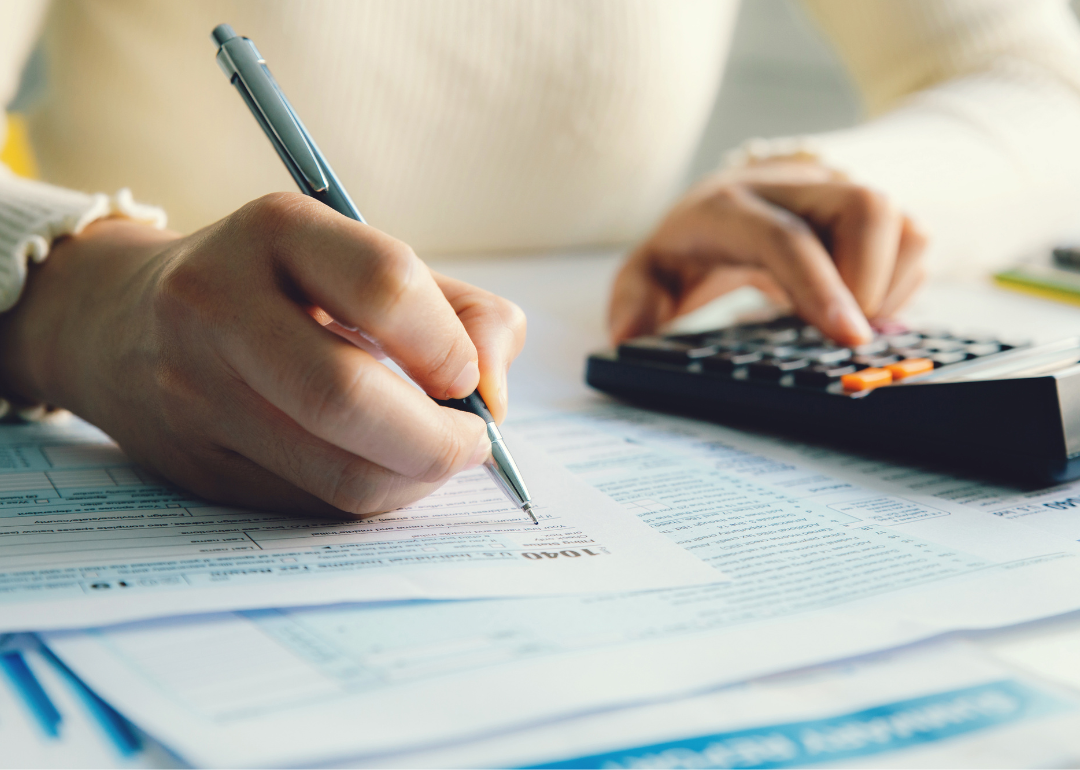 A person filling out an income tax form.