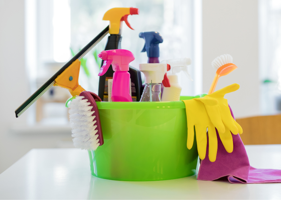 Natural cleaning supplies in a bucket on a counter