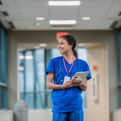 A registered nurse walking down a hallway