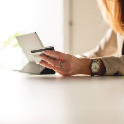 A woman typing in her credit card details while online shopping