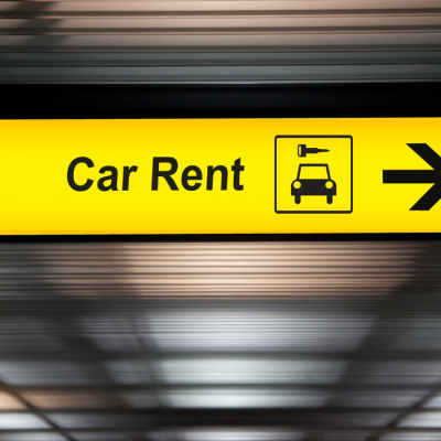 A sign pointing to where customers can rent a car