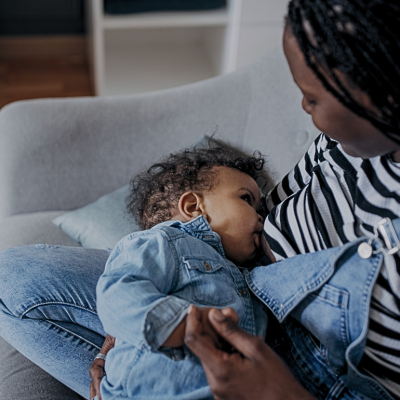 A mother breastfeeds a baby. 