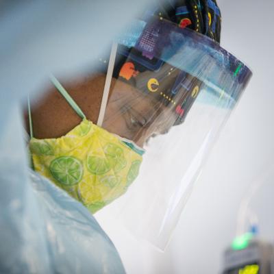 A nurse in a face shield.