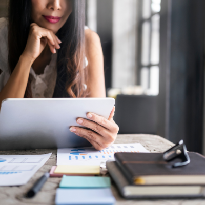 Woman looking at tablet and research.