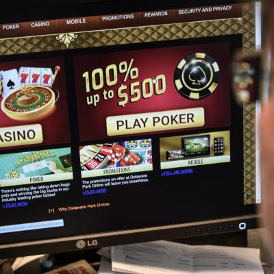 A person looking at a gambling website on a desktop computer.