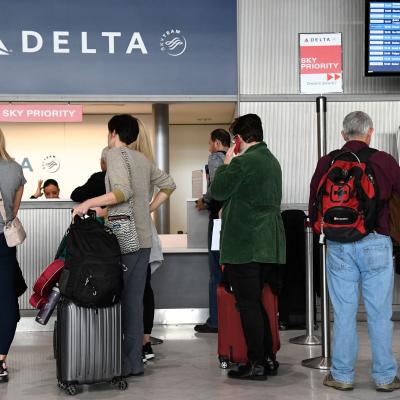 Travellers queue at a Delta Airlines desk at Paris-Charles-de-Gaulle airport.