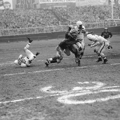 Marion Motley, Cleveland Browns Fullback is tackled.
