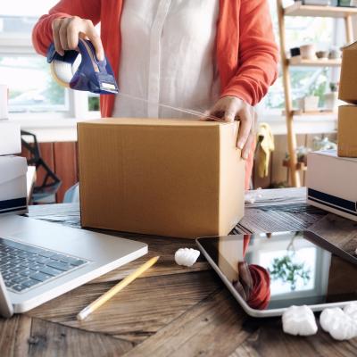 Business owner taping a package