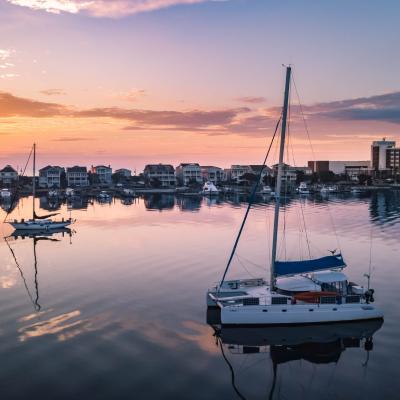 Catamaran on glassy water of intercoastal waterway in Wrightsville Beach.