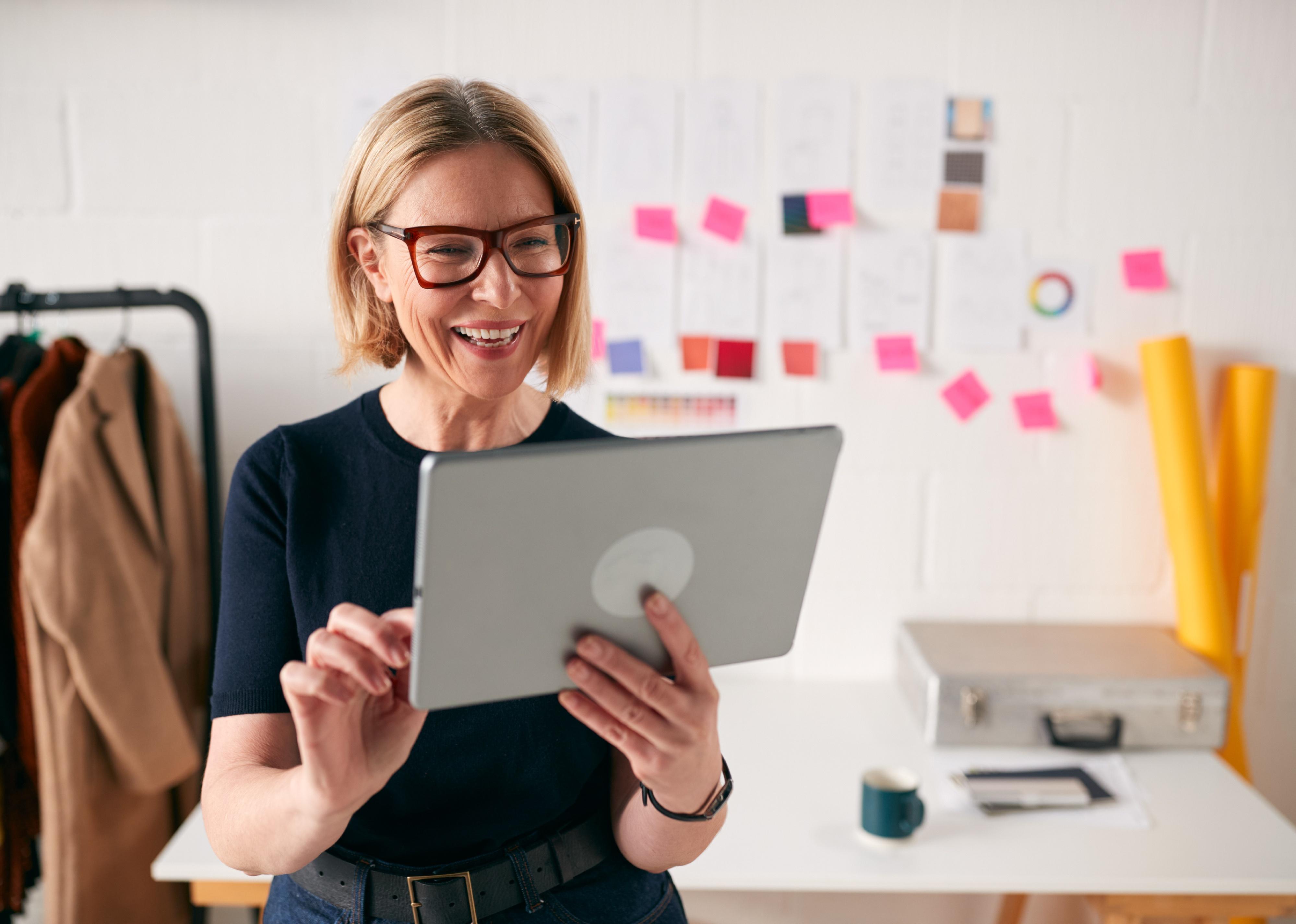 Businesswoman using tablet in studio of business.