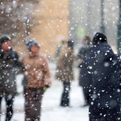 Pedestrians in a city during a severe blizzard.