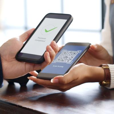 Customer using phone for payment via a QR code.