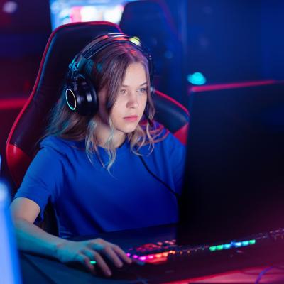 Young female gamer playing an online video game.
