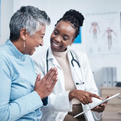 Doctor and elderly patient with a tablet.