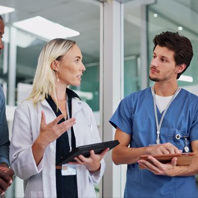 Health care staff having a standing meeting.
