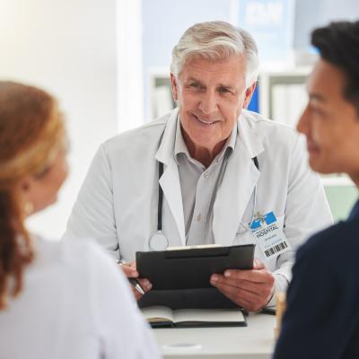 Doctor meeting a with a couple.
