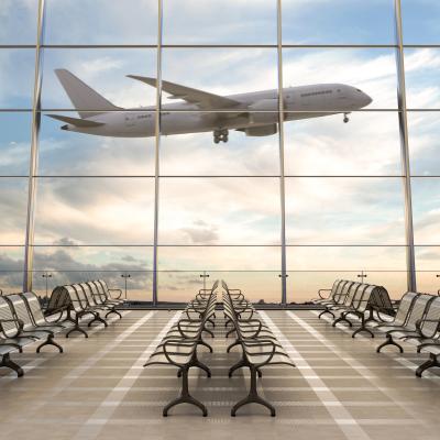 Empty airport terminal lounge with airplane on background. 
