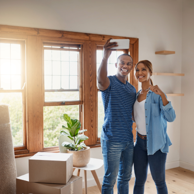 A young couple taking a selfie as they move into a new home.