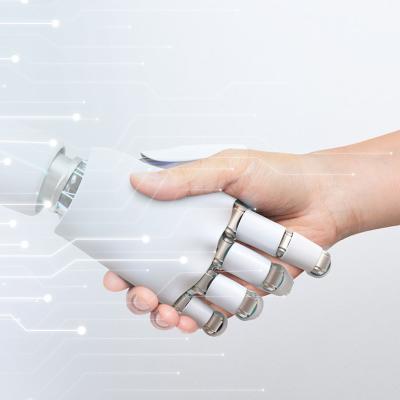Human hand shaking robot hand, symbolizing human-robot collaboration and technology.
