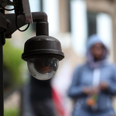 Close up of a video surveillance camera hanging from the side of a building in San Francisco. 
